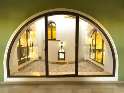 an arched window in a room with a building at Beachfront Villa with Private Pool and Exotic Fruit Garden in Pyla