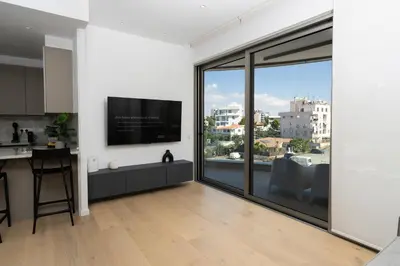 a kitchen and living room with a large window at WealthyStays Parkside Residence in Nicosia