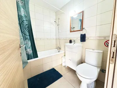 a bathroom with a toilet and a sink and a tub at Angela's Sunset Holiday Apt - Ayia Napa in Ayia Napa