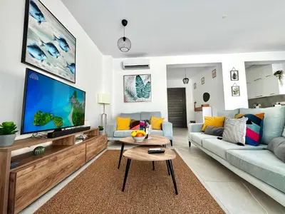 a living room with a large flat screen tv at STAY Villa Palm in Protaras