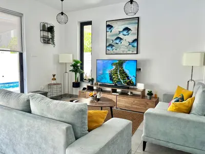 a living room with two couches and a flat screen tv at STAY Villa Palm in Protaras