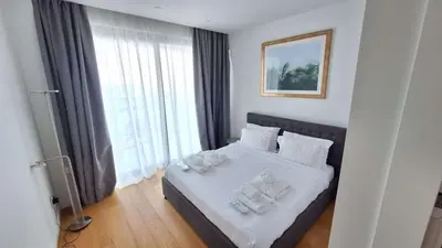 a bedroom with a bed with towels on it at Del Mar 2 bedroom Seaside 'A' Residence in Limassol