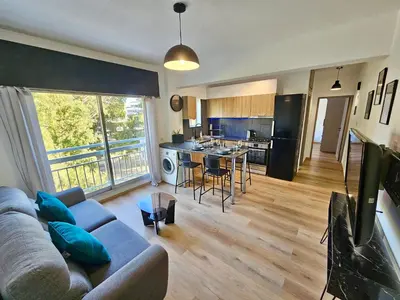 a living room with a couch and a kitchen at Central Riverside Escape Charming 1- Bedroom Flat in Limassol