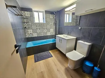 a bathroom with a toilet and a sink and a tub at Central Riverside Escape Charming 1- Bedroom Flat in Limassol