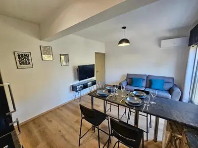 a living room with a table and a couch at Central Riverside Escape Charming 1- Bedroom Flat in Limassol