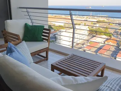 a living room with a view of the ocean at Awesome Sea & Marina View City Center 1 Bdr Flat in Larnaka
