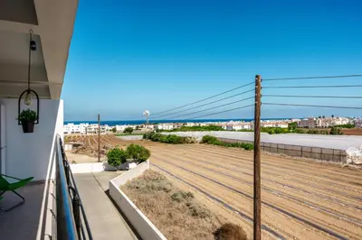 a balcony with a view of the ocean and a city at Spitaki 2 BDR Apartment with Pool and Close Proximity to Beach in Paralimni
