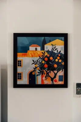 a painting of an orange tree hanging on a wall at Spitaki 2 BDR Apartment with Pool and Close Proximity to Beach in Paralimni