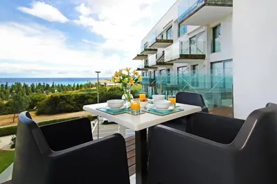 a table and chairs on the balcony of a building at Apartment Josephine - Beachfront in Protaras