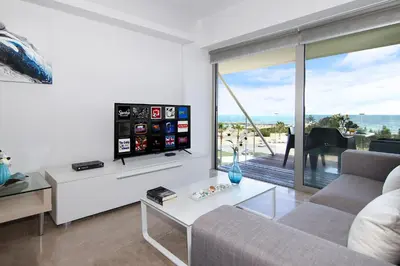 a living room with a couch and a tv at Apartment Josephine - Beachfront in Protaras