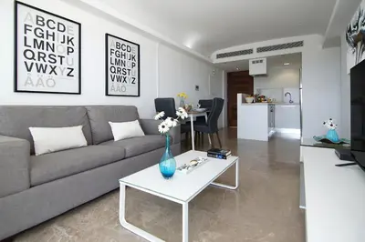 a living room with a couch and a table at Apartment Josephine - Beachfront in Protaras
