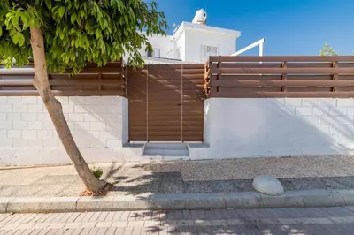 a wooden fence on the side of a house at Napa Centro Apartment in Ayia Napa
