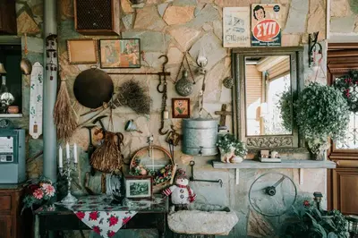 a room with a stone wall with a table and a mirror at Kyperounta Retreat in Kyperounda