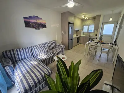 a living room with a couch and a table at Seaside Escape Apartment in Larnaka