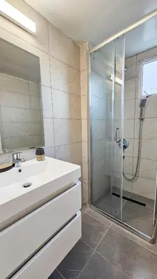 a bathroom with a sink and a shower at La Magenta Apartments in Pyla