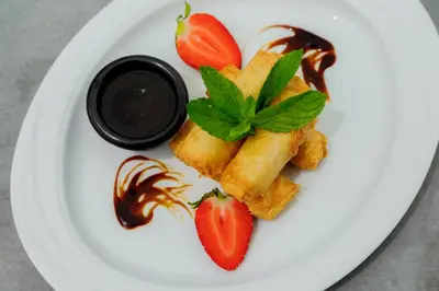 a plate of food with strawberries and chocolate on it at Vassos Nissi Plage Hotel & Spa in Ayia Napa