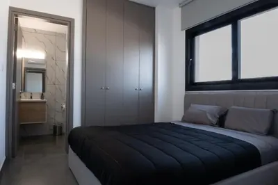 a bedroom with a large bed and a window at Luxurious two bedroom apartment with roof garden in Kato Lakatamia