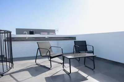 two chairs and a table on a roof at Luxurious two bedroom apartment with roof garden in Kato Lakatamia