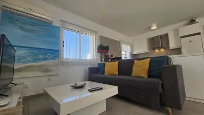 a living room with a couch and a table at STAY Villa Harsha in Ayia Napa