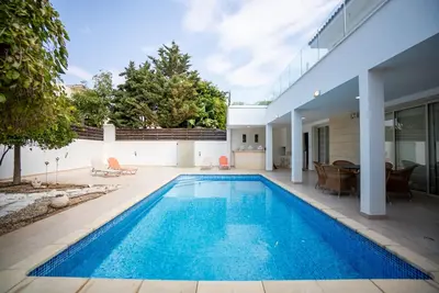 a swimming pool in the backyard of a house at Beachfront Villa Larnaka Dhekelia with Pool in Pyla