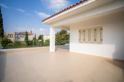 a white house with a patio with a window at Beachfront Villa Larnaka Dhekelia with Pool in Pyla