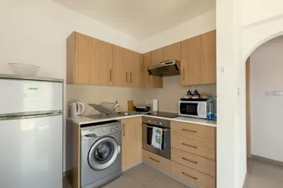 a kitchen with a washing machine and a refrigerator at Obv 2304 in Pyla
