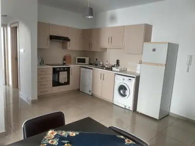 a kitchen with a refrigerator and a washing machine at Oceania Bay Residence in Pyla