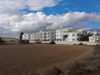 a row of white apartment buildings in a field at Oceania Bay Residence in Pyla