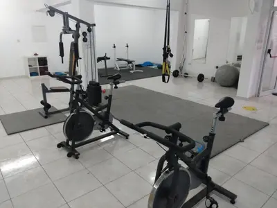 a gym with several treadmills and exercise bikes at Oceania Bay Residence in Pyla