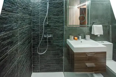 a bathroom with a sink and a shower at Mackenzie Suite in Larnaka