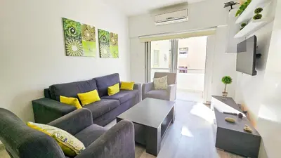 a living room with a couch and a table at Blue Sky Ocean Retreat in Larnaka
