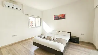 a bedroom with a bed with two white dogs on it at Blue Sky Ocean Retreat in Larnaka