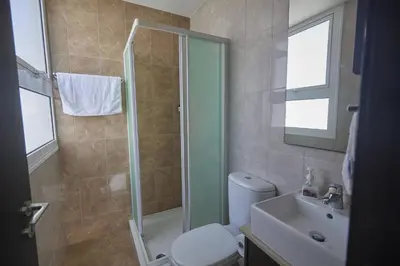 a bathroom with a shower and a toilet and a sink at Protaras Pearl Villa Pe15 in Protaras