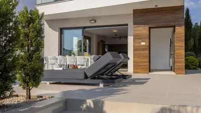 a patio with chairs and a table in a house at Nissi Residences Villa 4 in Ayia Napa