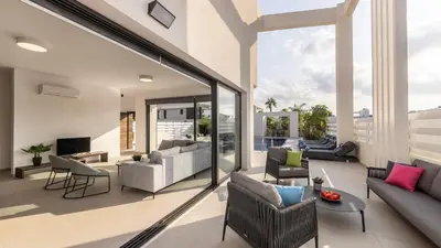 a living room with a couch and chairs at Nissi Residences Villa 4 in Ayia Napa