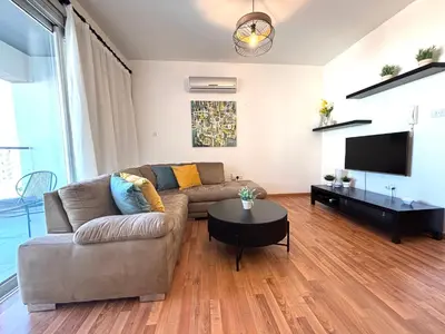 a living room with a couch and a tv at One Bedroom Flat in Central Nicosia in Nicosia