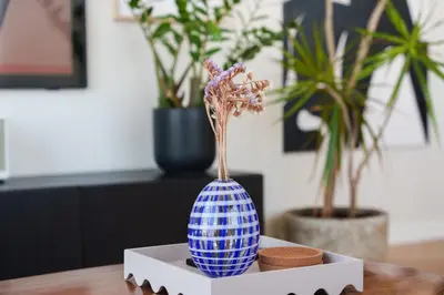 a blue and white vase on a table with plants at Penthouse Living in the Heart of Nicosia in Nicosia