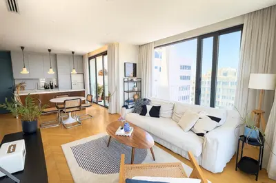 a living room with a white couch and a table at Penthouse Living in the Heart of Nicosia in Nicosia