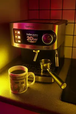 a cup of coffee sitting next to a coffee maker at Sea view Beach House with Pool in Limassol
