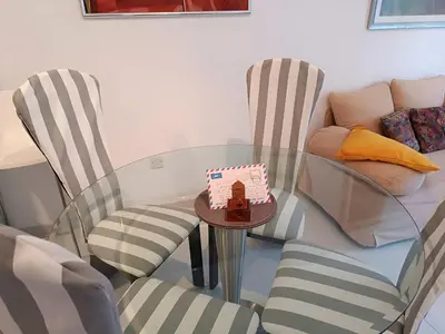 a glass table and chairs with a cake on a table at Sea view Beach House with Pool in Limassol