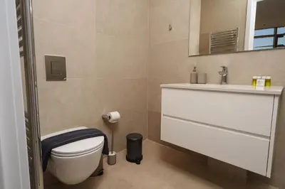 a bathroom with a toilet and a sink at 360 Sky Residence, Gym & Pool - 26th Floor in Nicosia