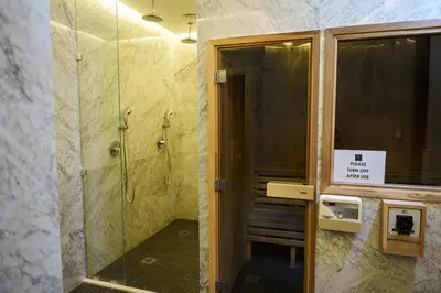 a bathroom with a shower and a glass door at 360 Sky Residence, Gym & Pool - 26th Floor in Nicosia