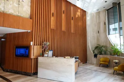 an office lobby with a reception desk and wooden walls at 360 Sky Residence, Gym & Pool - 26th Floor in Nicosia