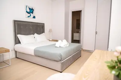 a bedroom with a large bed with white pillows at 360 Sky Residence, Gym & Pool - 26th Floor in Nicosia