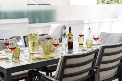 a table with wine glasses and bottles of wine at Serene Villa Retreat in Protaras in Paralimni