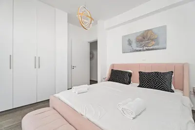 a large bed with a pink headboard in a bedroom at Serene Villa Retreat in Protaras in Paralimni