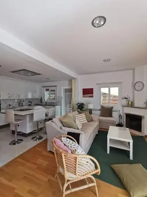 a living room with a couch and a kitchen at Cozy Family Home in Laxia