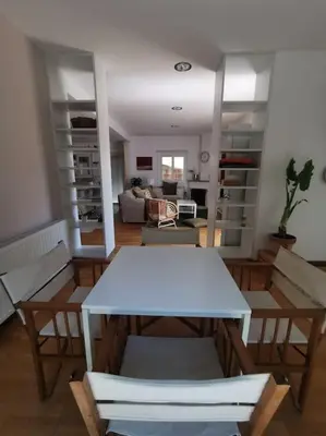 a living room with a white table and chairs at Cozy Family Home in Laxia