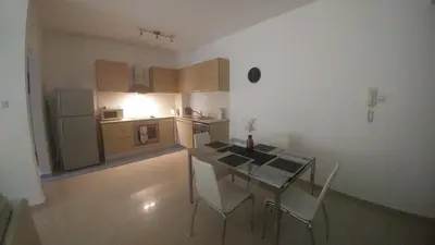 a kitchen with a table and chairs in a room at Emerald Heights in Tersephanou