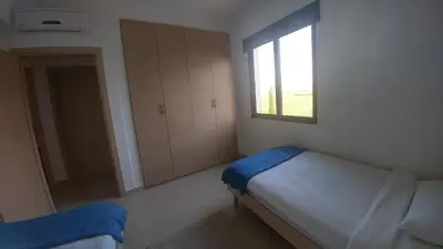 a small bedroom with a bed and a window at Emerald Heights in Tersephanou